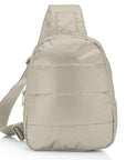 Puffer crossbody backpack in shimmer beige on white background