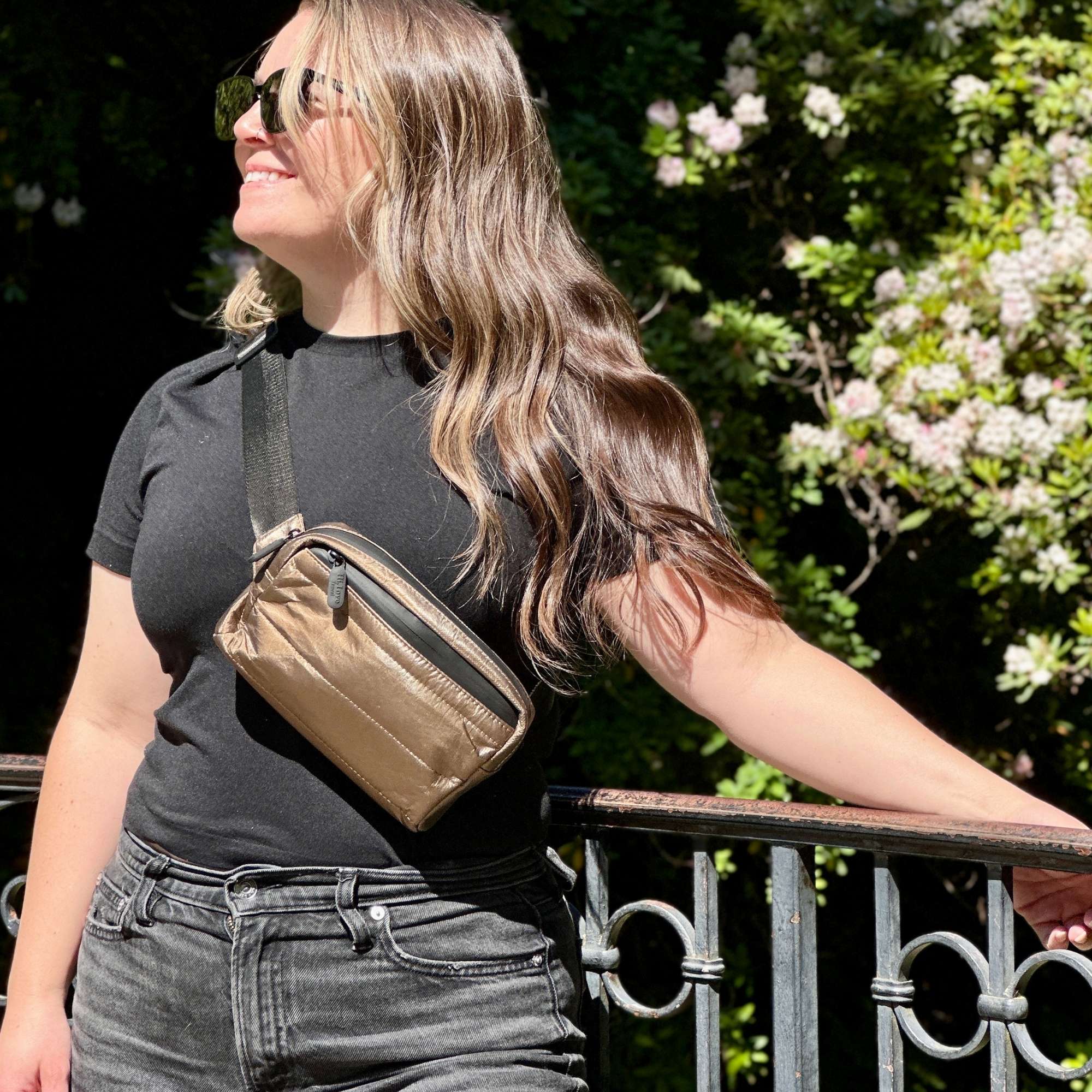 Woman wearing crossbody fanny pack belt bag in Shimmer Bronze Black Strap