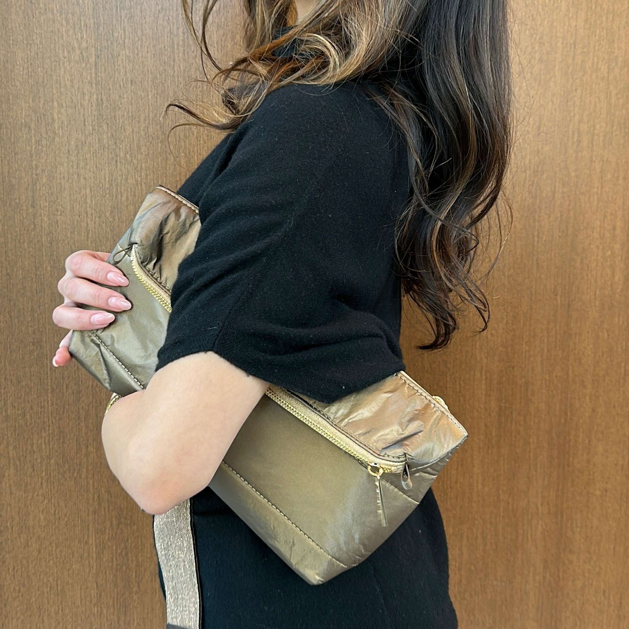 Woman wearing fold over Clutch in Shimmer Bronze Gold Zipper