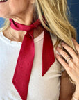 Women wearing a red tonal printed scarfette around her neck.