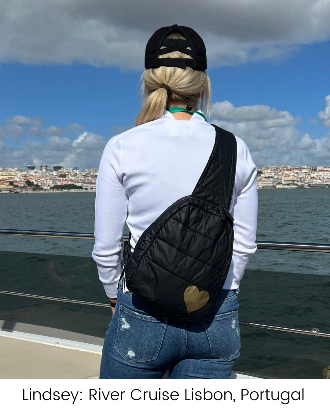 Woman standing on boat wearing black crossbody backpack