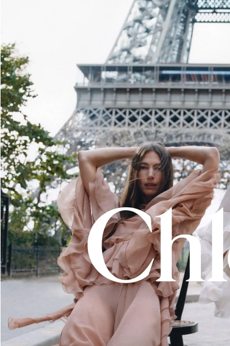 Woman posing in front of the eiffel tower in Chloe magazine layout