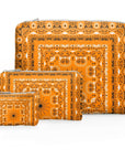 Set of three orange bandana patterned pouches on a white background