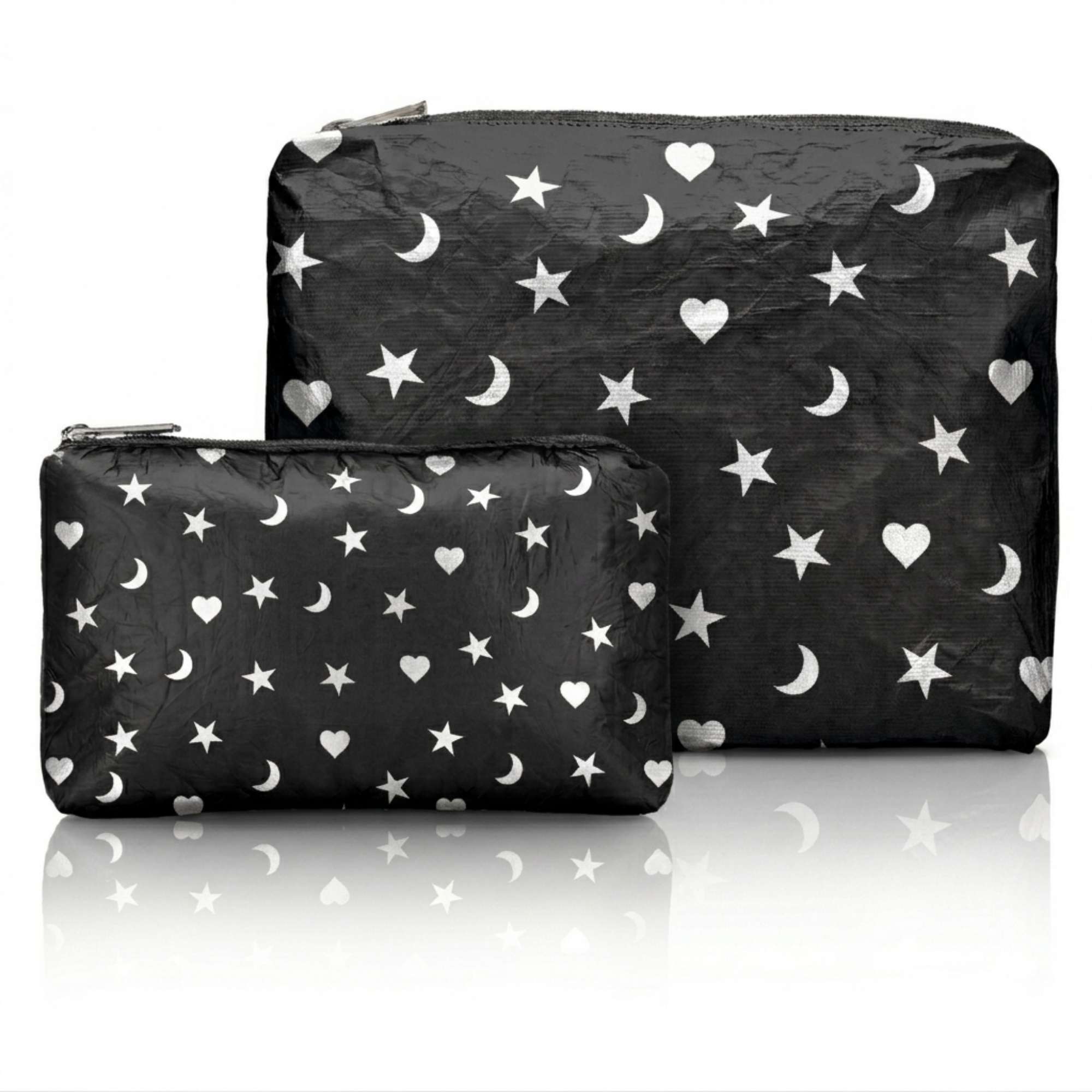 Two black pouches, one medium pouch and one mini pouch, with white star, moon and heart patterns on a white background 