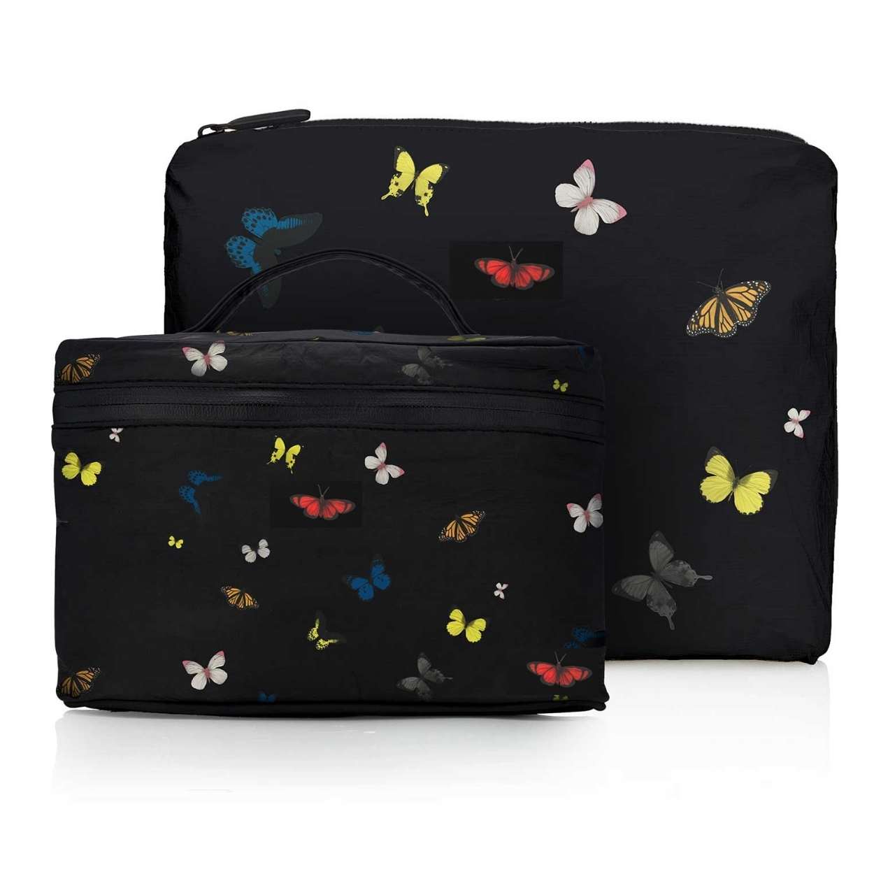 Two black pouches with colorful butterfly patterns on a white background