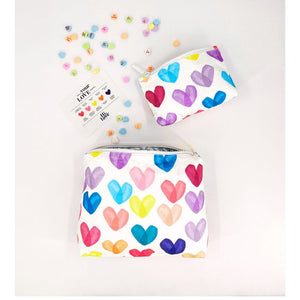 Two size zipper pouches with Brightly colored heart print