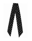 A black neck scarf with a repeating pattern of white hearts, stars and crescent moons, laid flat against a solid white background.