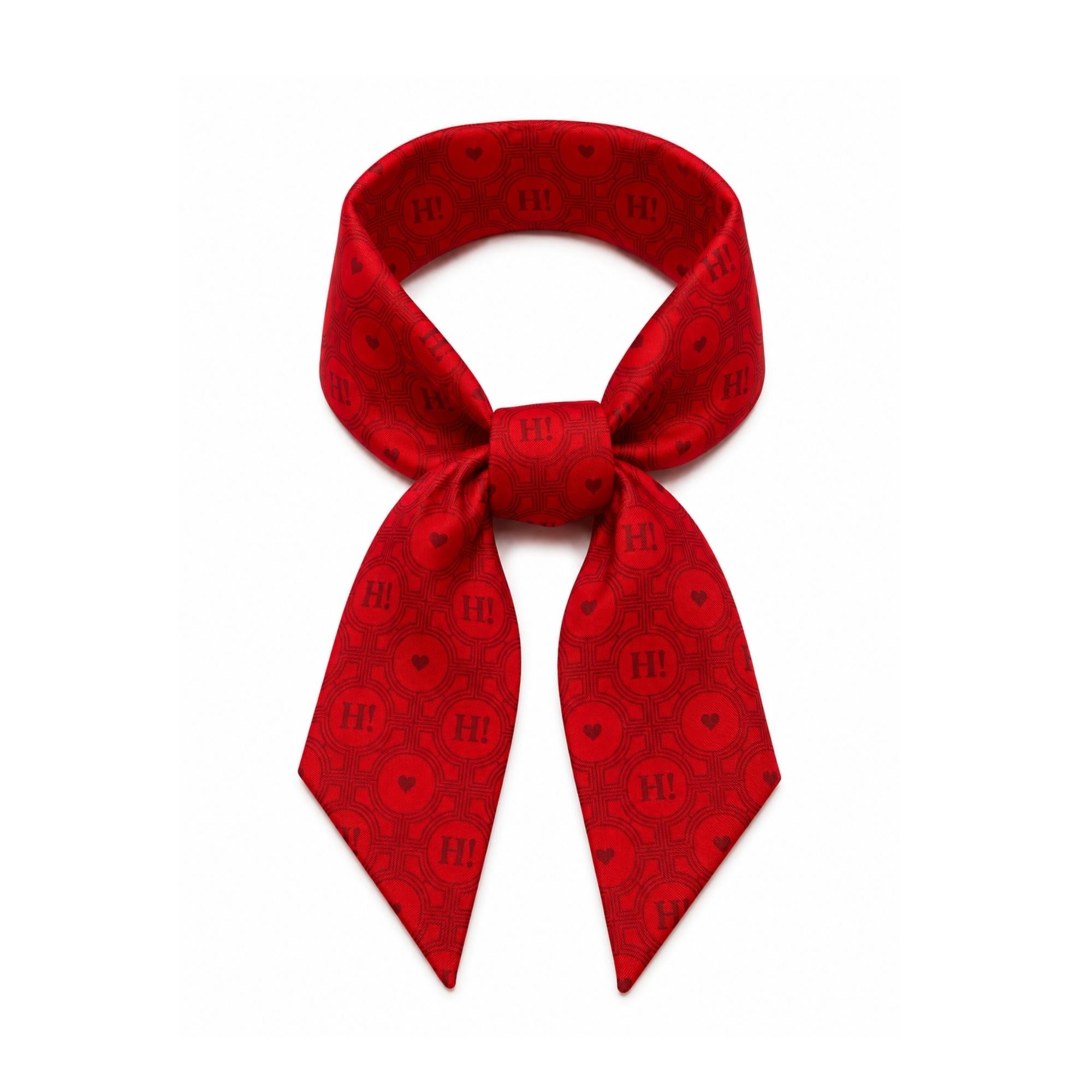 Red silk scarfette featuring the Signature Hi Print, styled as a versatile accessory for handbags, hair, neck, or wrist.