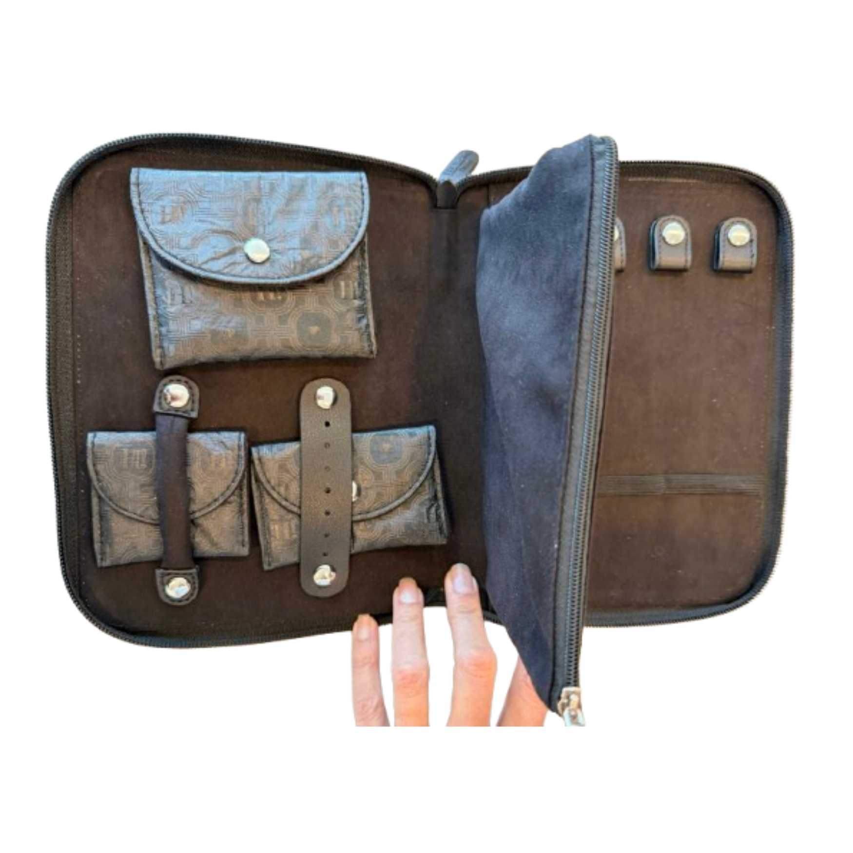 Open black travel jewelry organizer featuring storage for rings, earrings, necklaces, and small jewelry essentials.