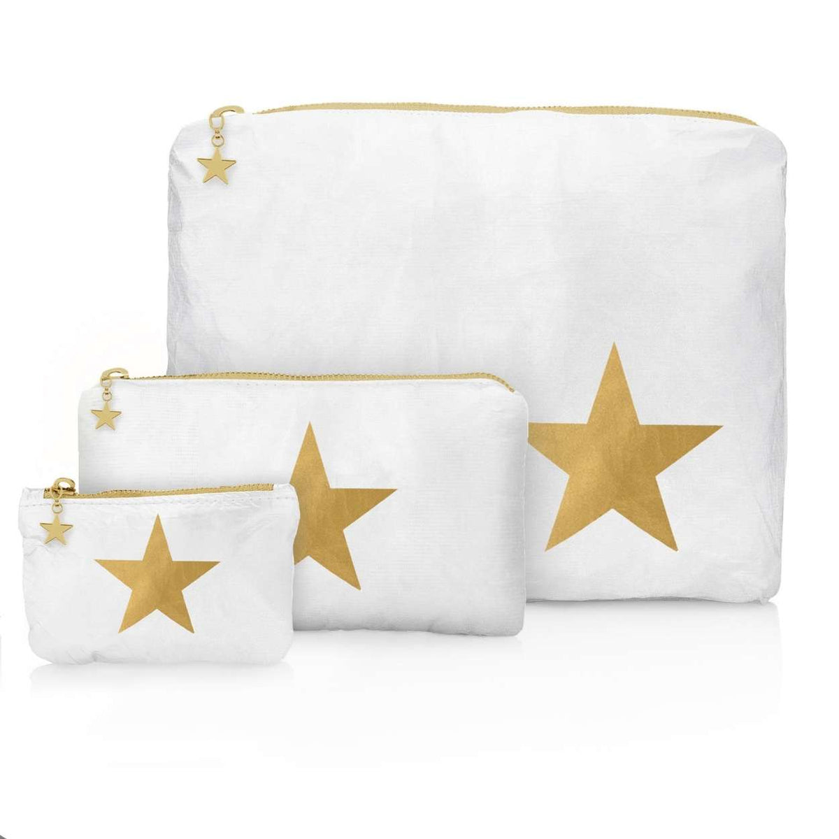 Three white zippered storage pouches in different sizes, each featuring a large metallic gold star on the front and a small gold star charm on the zipper pull, displayed on a clean white background.