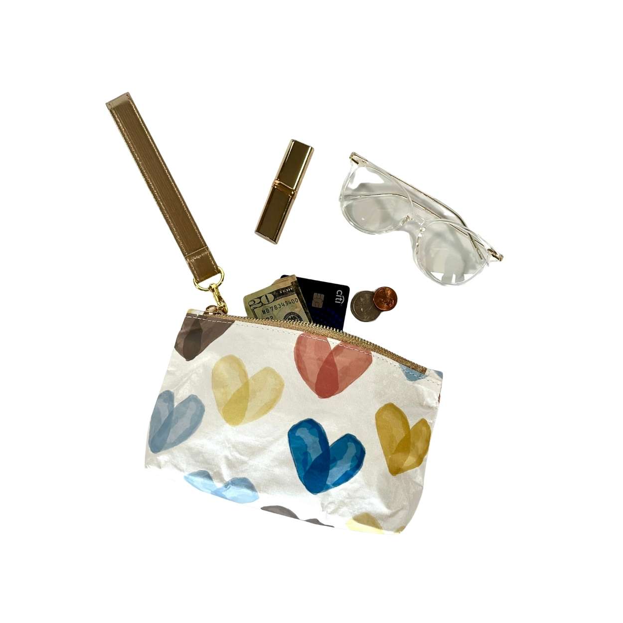 Small pouch with colorful heart designs containing glasses money lipstick on a white background