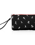 A black zippered wristlet pouch with a repeating white silhouette pattern of skiers and snowboarders, featuring a black wristlet strap and a red zipper trim.