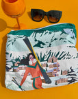 Woman's Clutch Zipper Pouch with Skier sitting on table with sunglasses