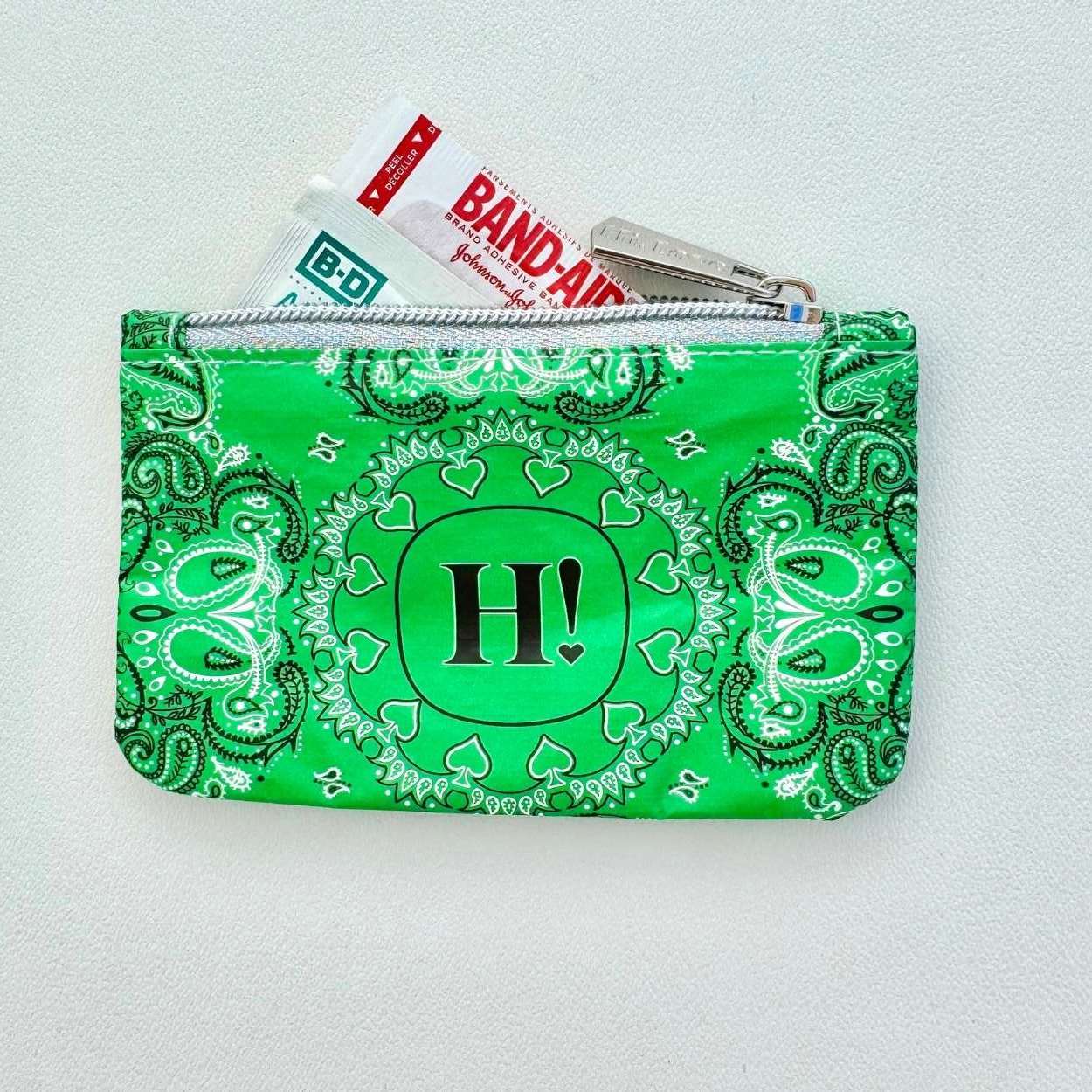 Green bandana-patterned pouch with 'H!' on a white background