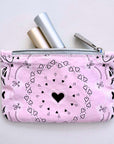 Pink pouch with black heart bandana pattern on a light gray background
