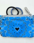 Blue bandana-patterned pouch with a black heart design on a white background
