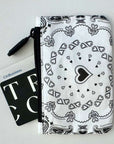 Black and white bandana patterned pouch with a card on a light gray background