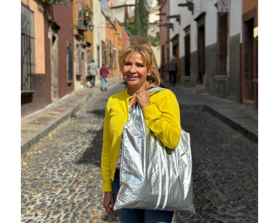 Woman in yellow sweater holding silver tote bag on the streets in Mexico