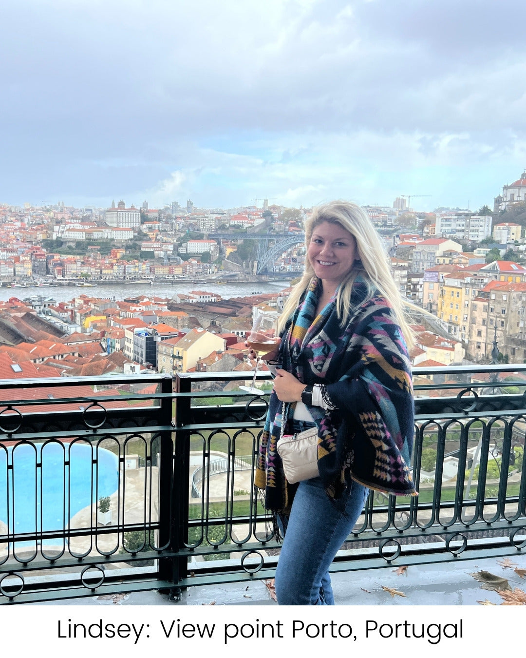 Woman standing on roof top over looking Porto Portugal wearing beige purse