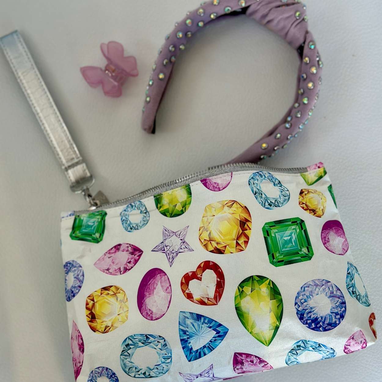 Small pouch with gemstone pattern and headband on a light gray background