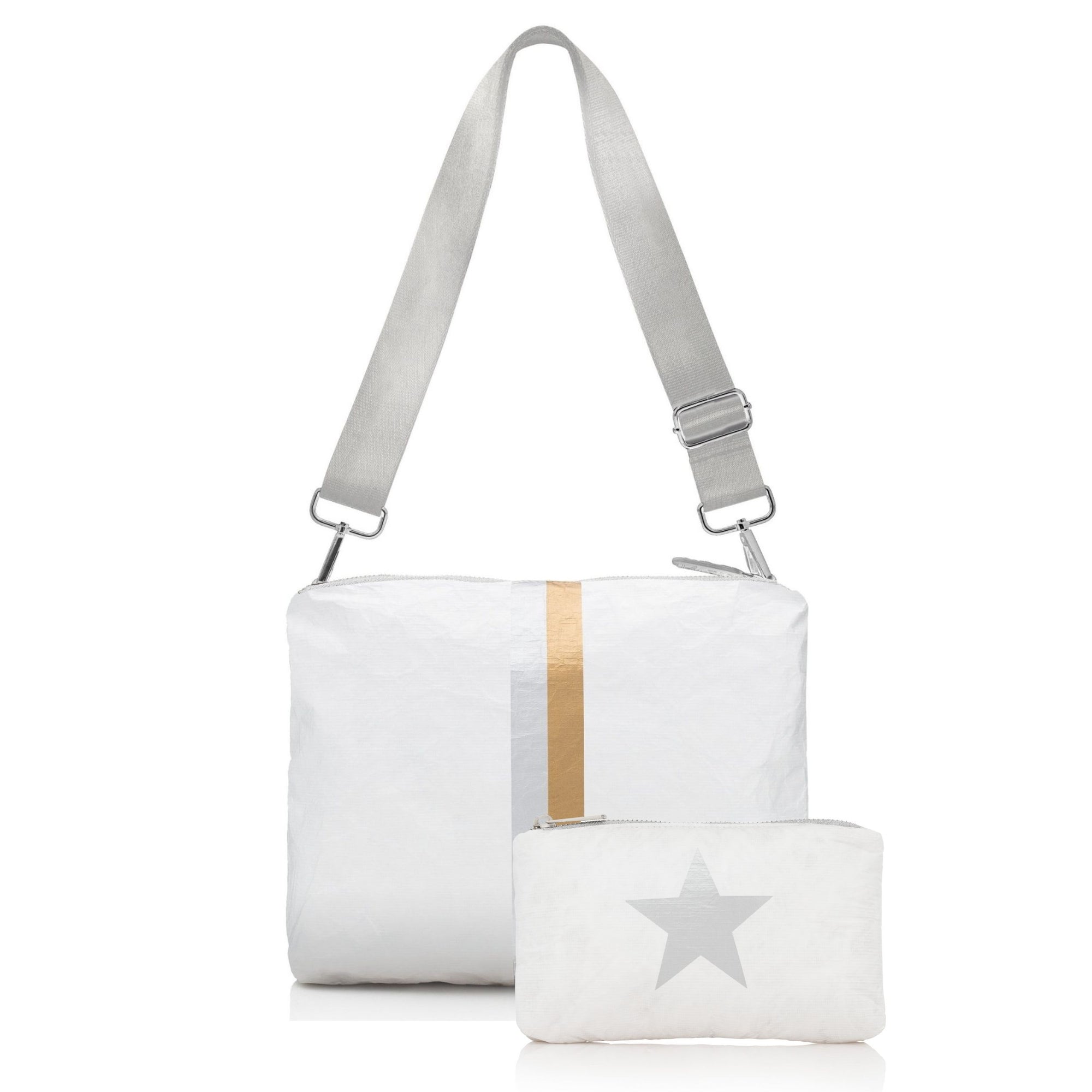 White shimmer crossbody purse with adjustable strap and matching mini zip pouch with silver star, shown together against white background.