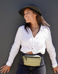 Woman wearing Puffer Crossbody Fanny Pack Belt Bag in Shimmer Olive Green