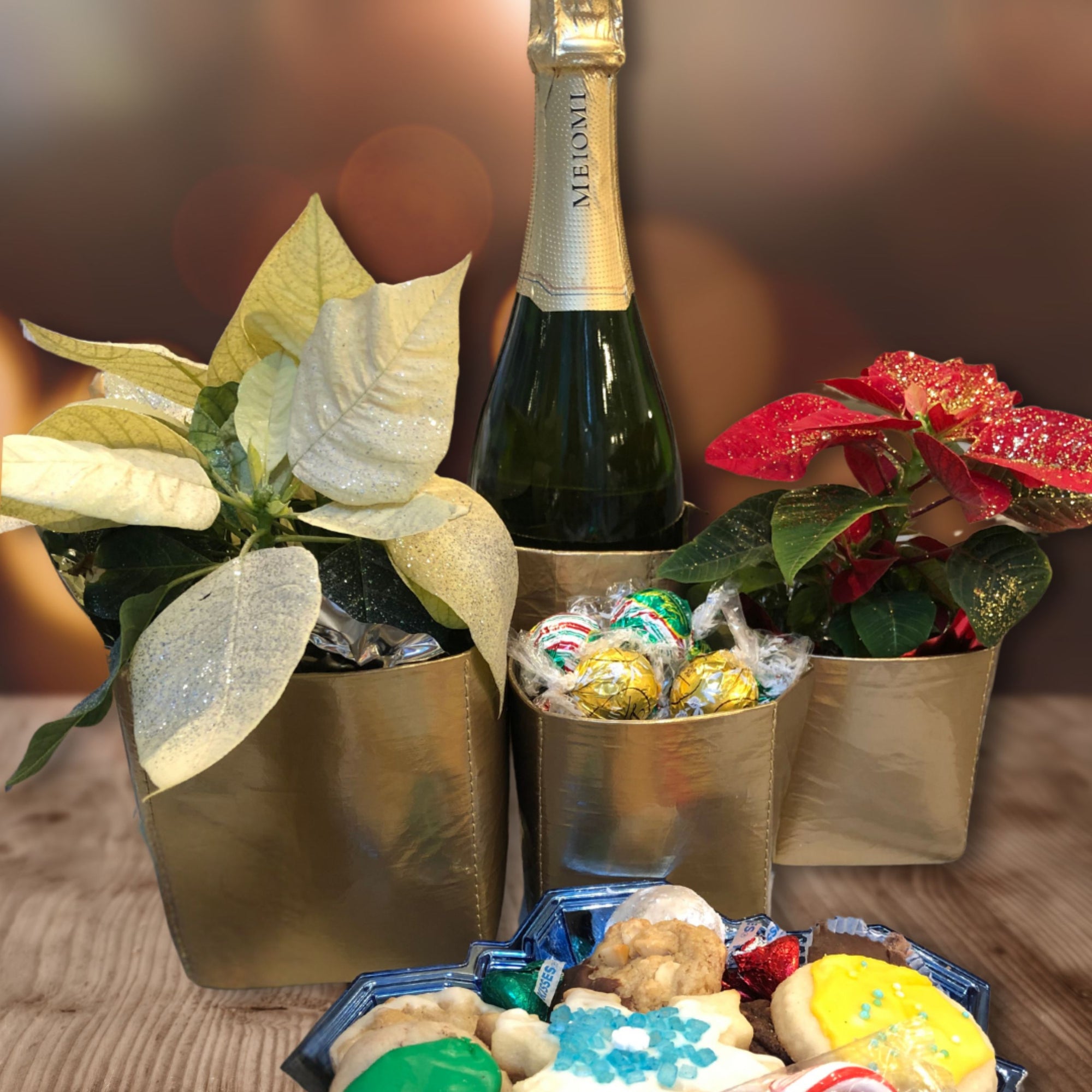 Set of two gold cup organizers with holiday candies and plants inside