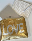 Computer in Jumbo zipper pouch in gold with silver LOVE on white background