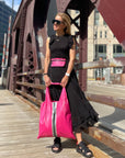 Woman wearing hot pink fanny pack and holding hot pink tote bag