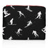 Medium Zipper Pouch Dancing Skiers II Black & White featuring a black background with white skier silhouettes in motion and a contrasting red zipper on a white background.