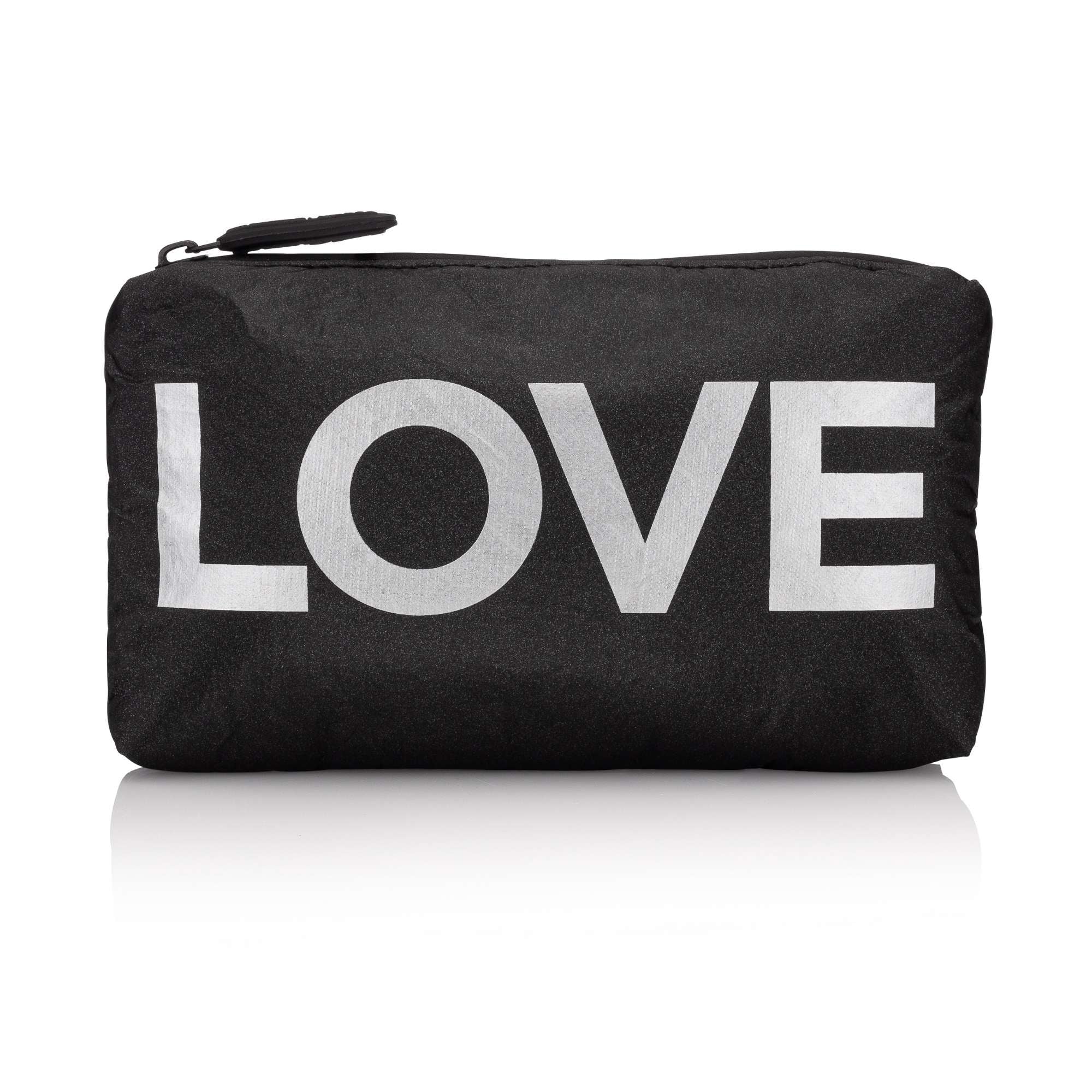 A black zippered cosmetic pouch with the word 'LOVE' printed in large, bold, silver glitter letters across the front, set against a plain white background with a soft reflection below.