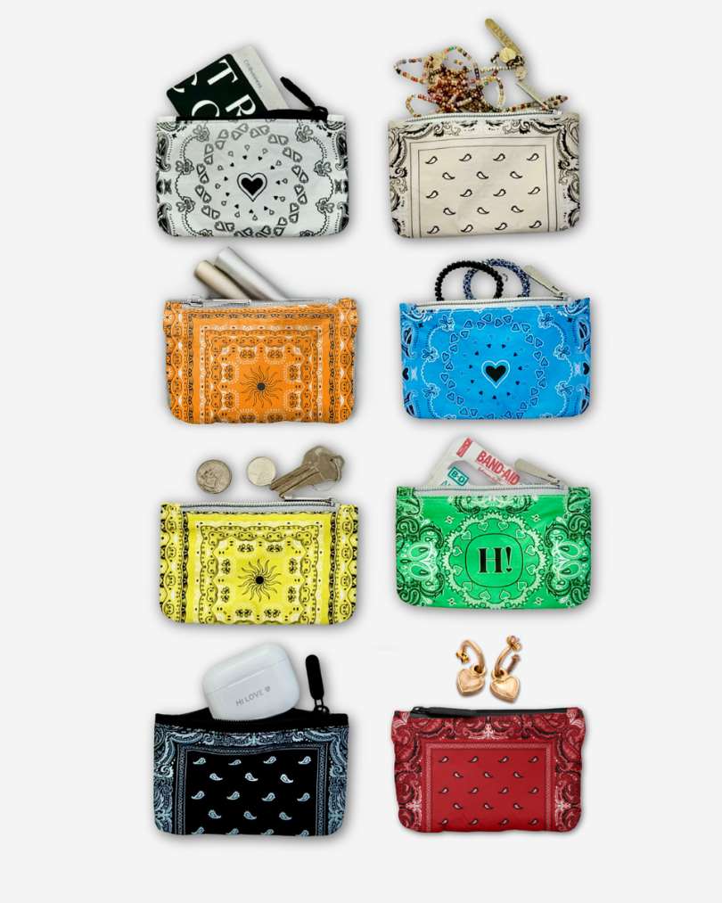 Collection of colorful bandana-patterned pouches in white, orange, beige, blue, yellow, green, black, and red and accessories on a white background 