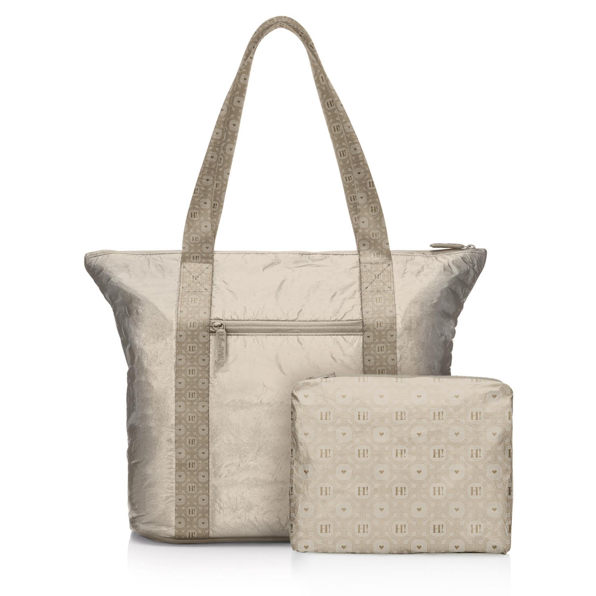 Woman traveling with a beige Signature travel tote and matching medium pouch.