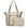 Woman traveling with a beige Signature travel tote and matching medium pouch.