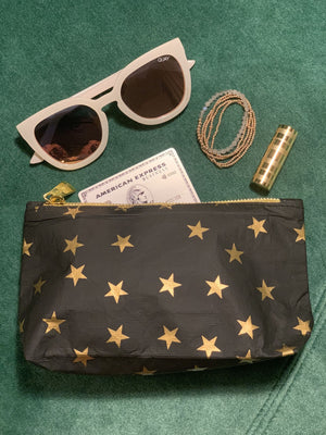 Versatile mini zipper pouch in black with myriad of gold stars 