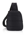 Black puffer crossbody sling backpack with a single padded strap and front zipper on white background