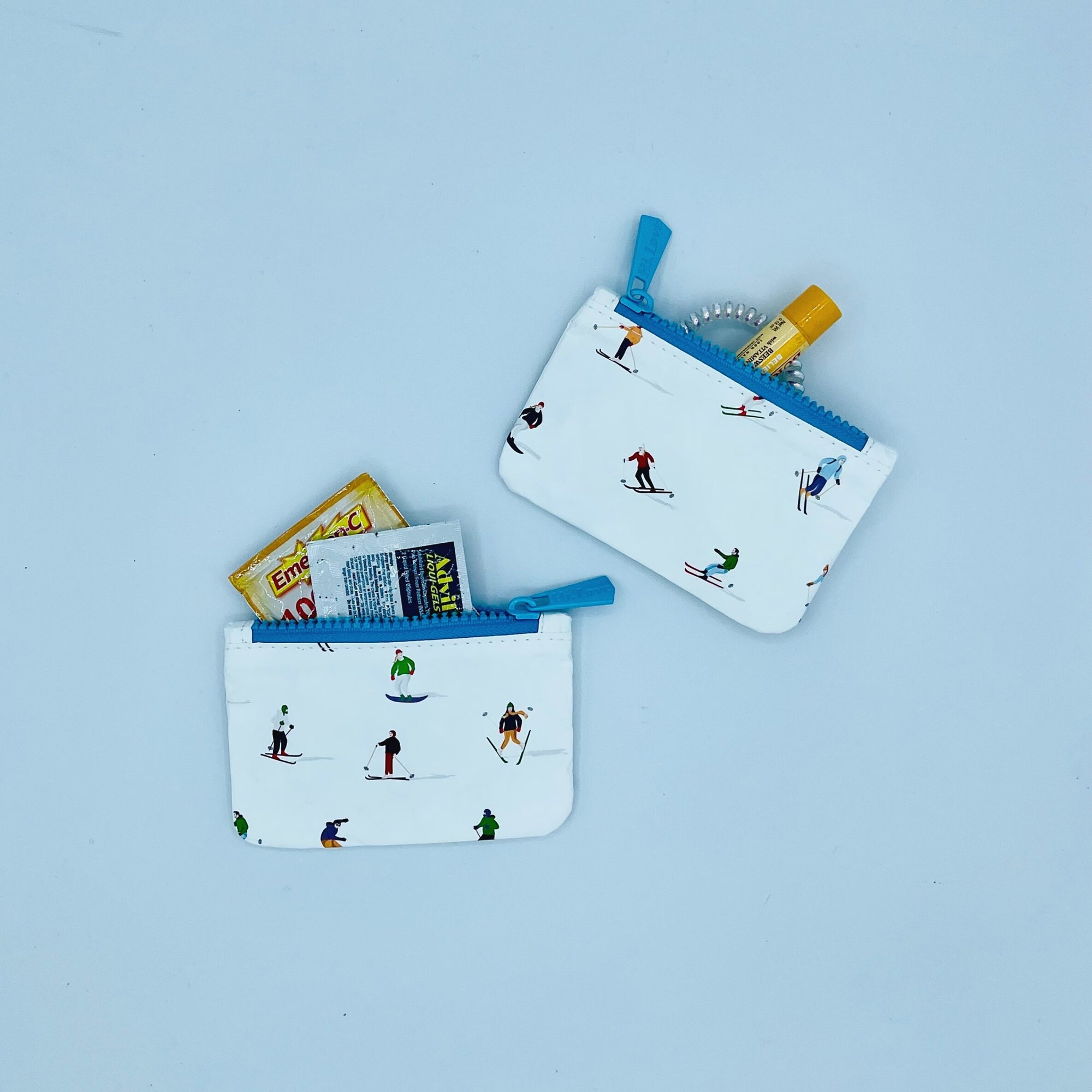 small pouch set with dancing skiers and snowboarders