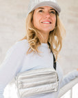 Woman wearing Puffer Crossbody Fanny Pack Belt Bag in Silver with Black Strap