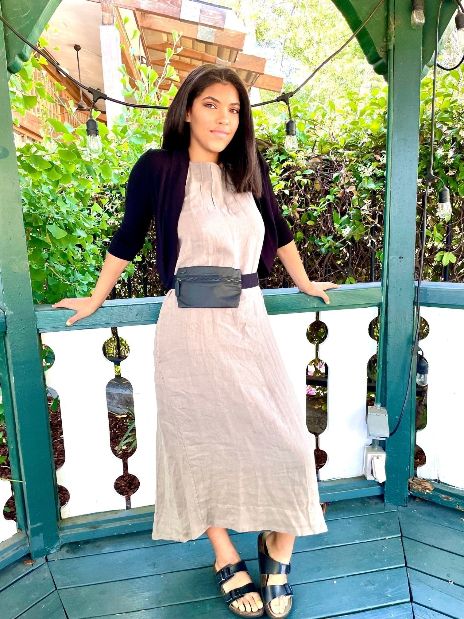 Woman outdoors wearing lay flat fanny pack belt bag in black 