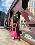 Woman on Chicago bridge holding hot pink tote bag