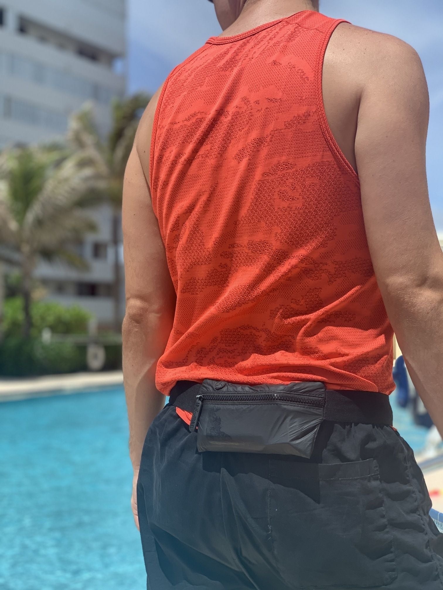 Person by pool wearing black fanny pack