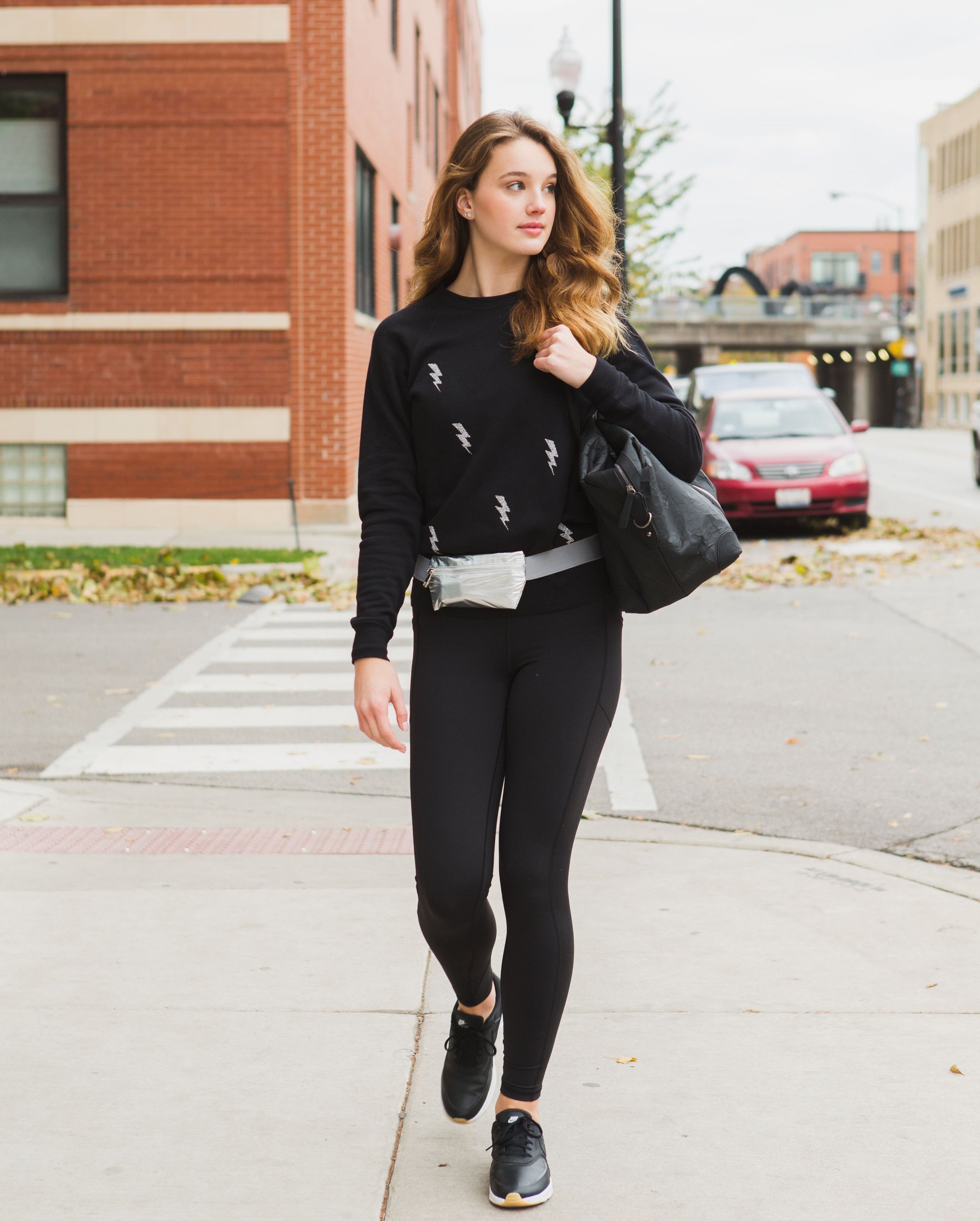 Woman walking wearing Layflat Fanny Pack Belt Bag in Silver with Gray Strap