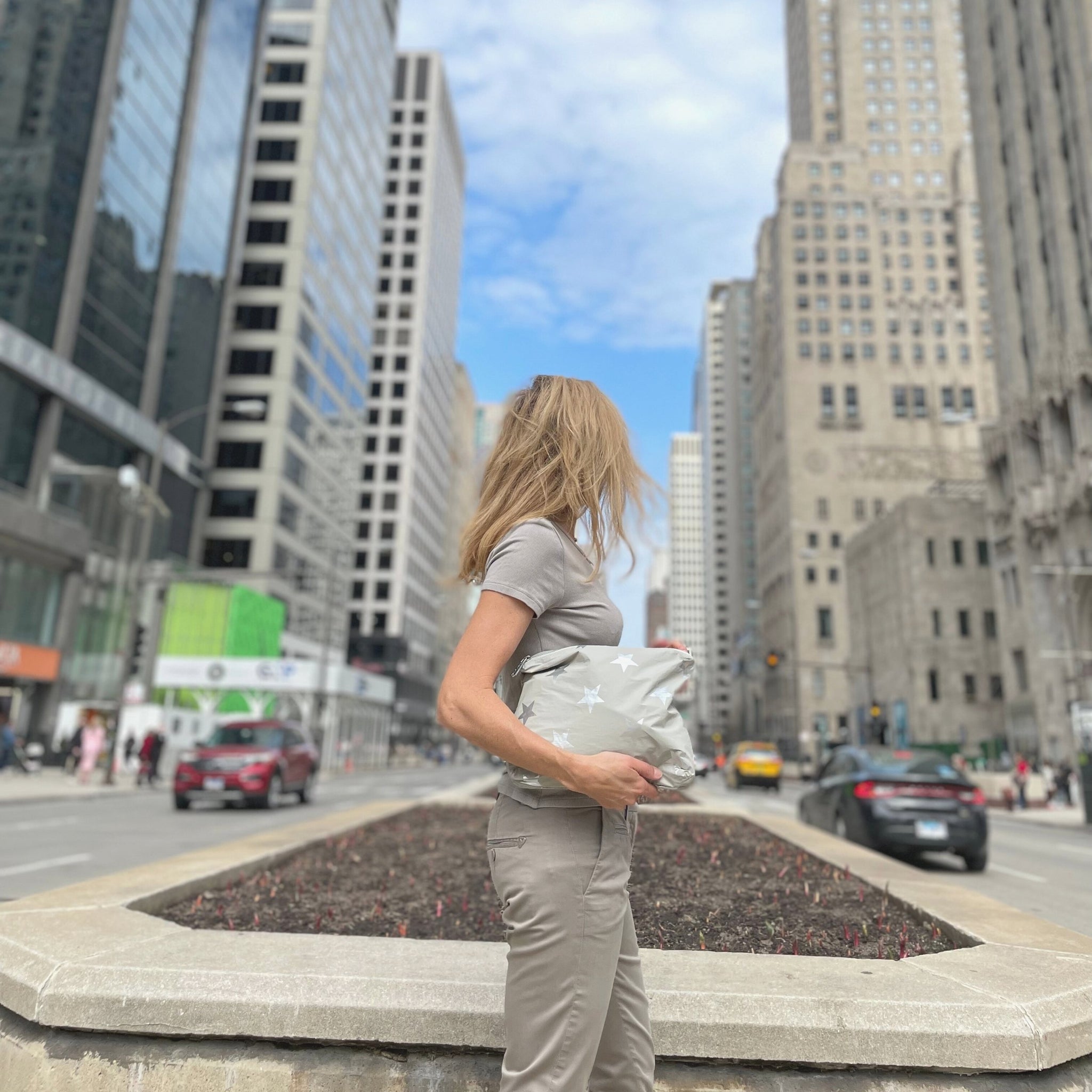 woman carrying medium pack in city setting