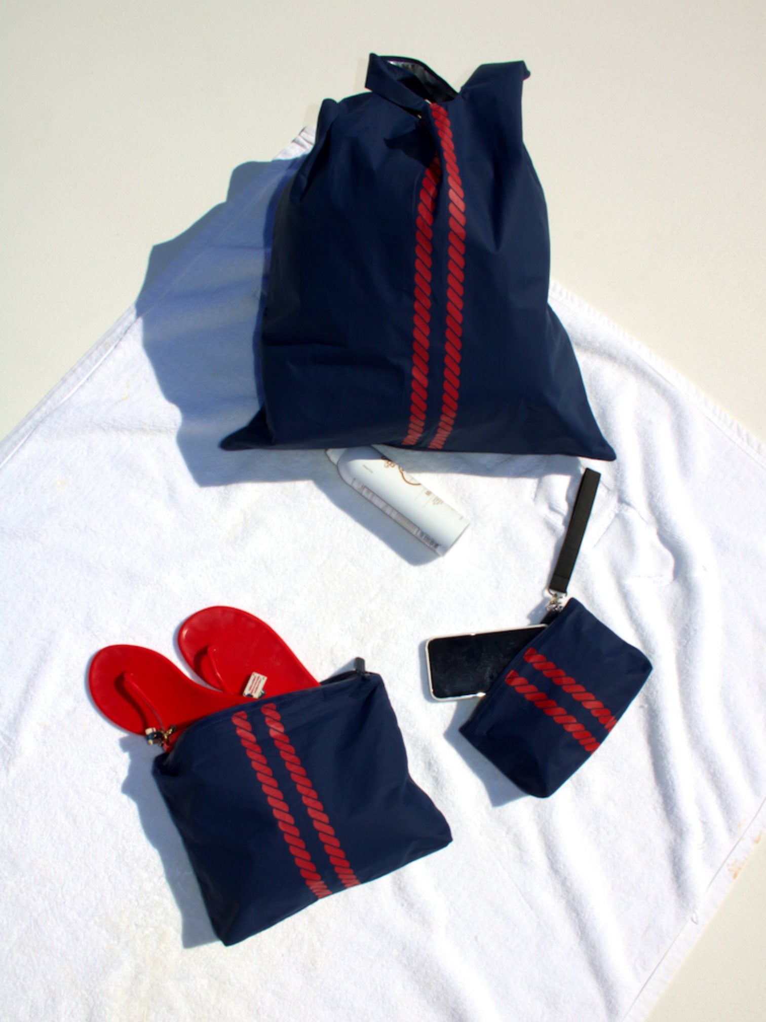 navy blue organizational zipper packs with red stripes