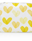 A medium-sized zipper pouch with a sunshine yellow heart print on a white background