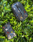 Mini pouch and cosmetic case in black with butterflies on plant background
