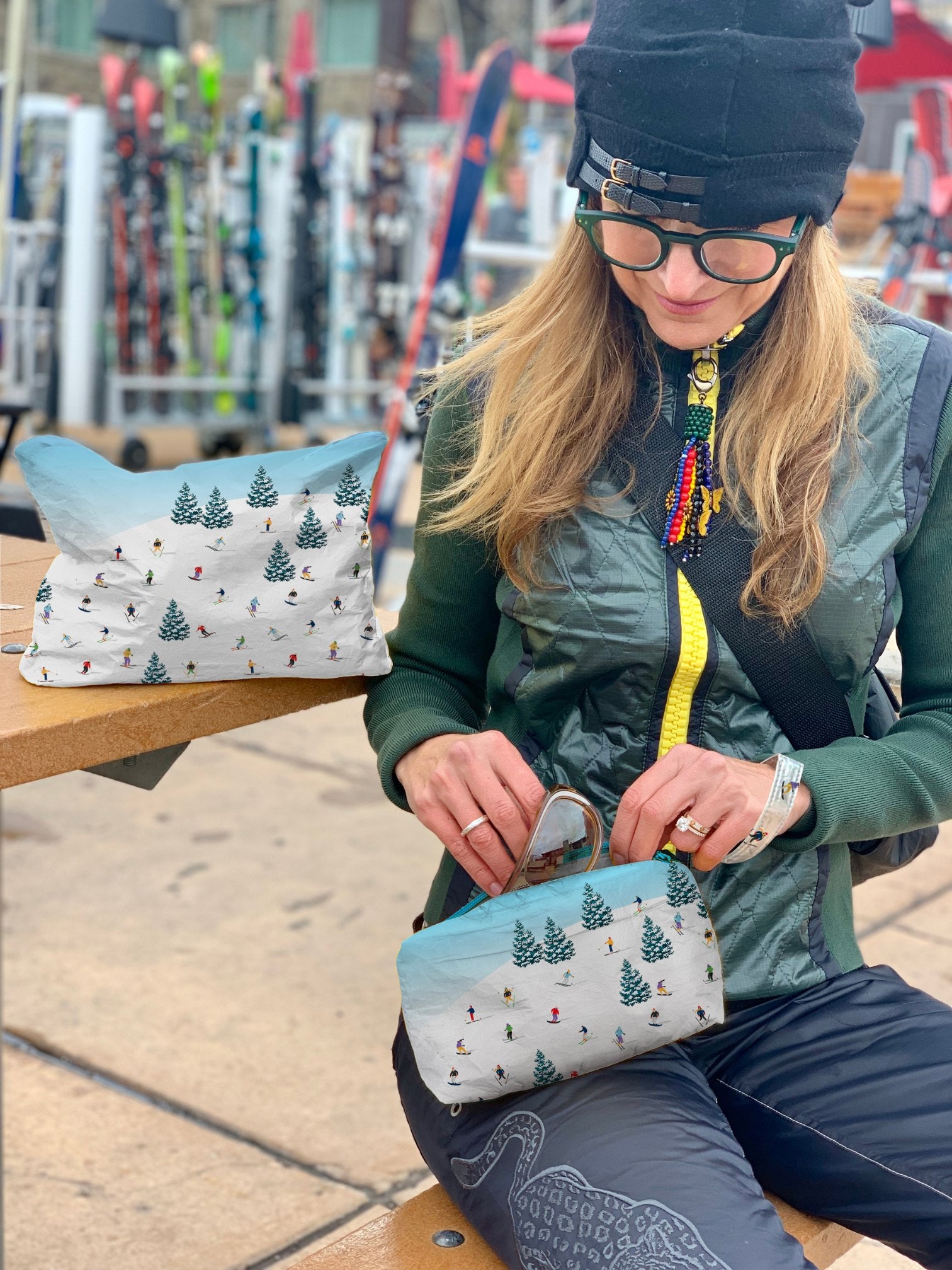 woman with mini zipper pouch organization while you ski