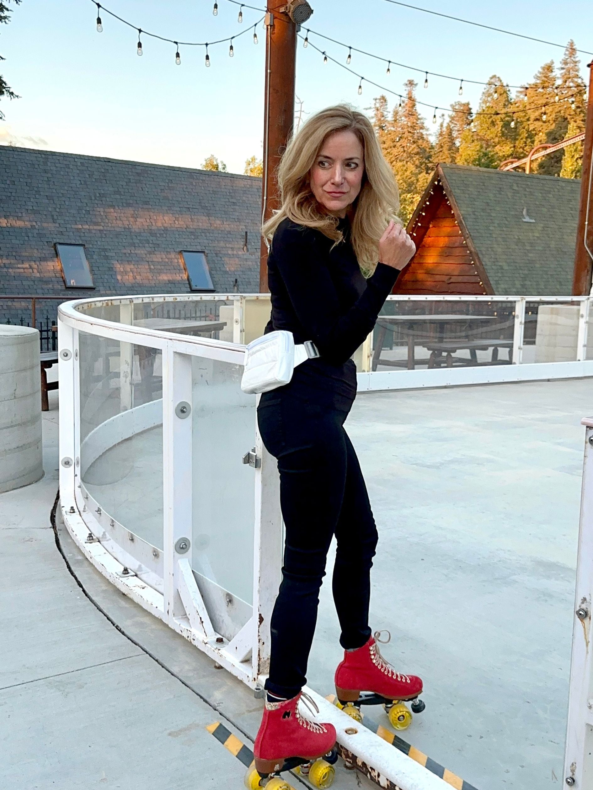 Woman roller blading with shimmer white puffer fanny pack
