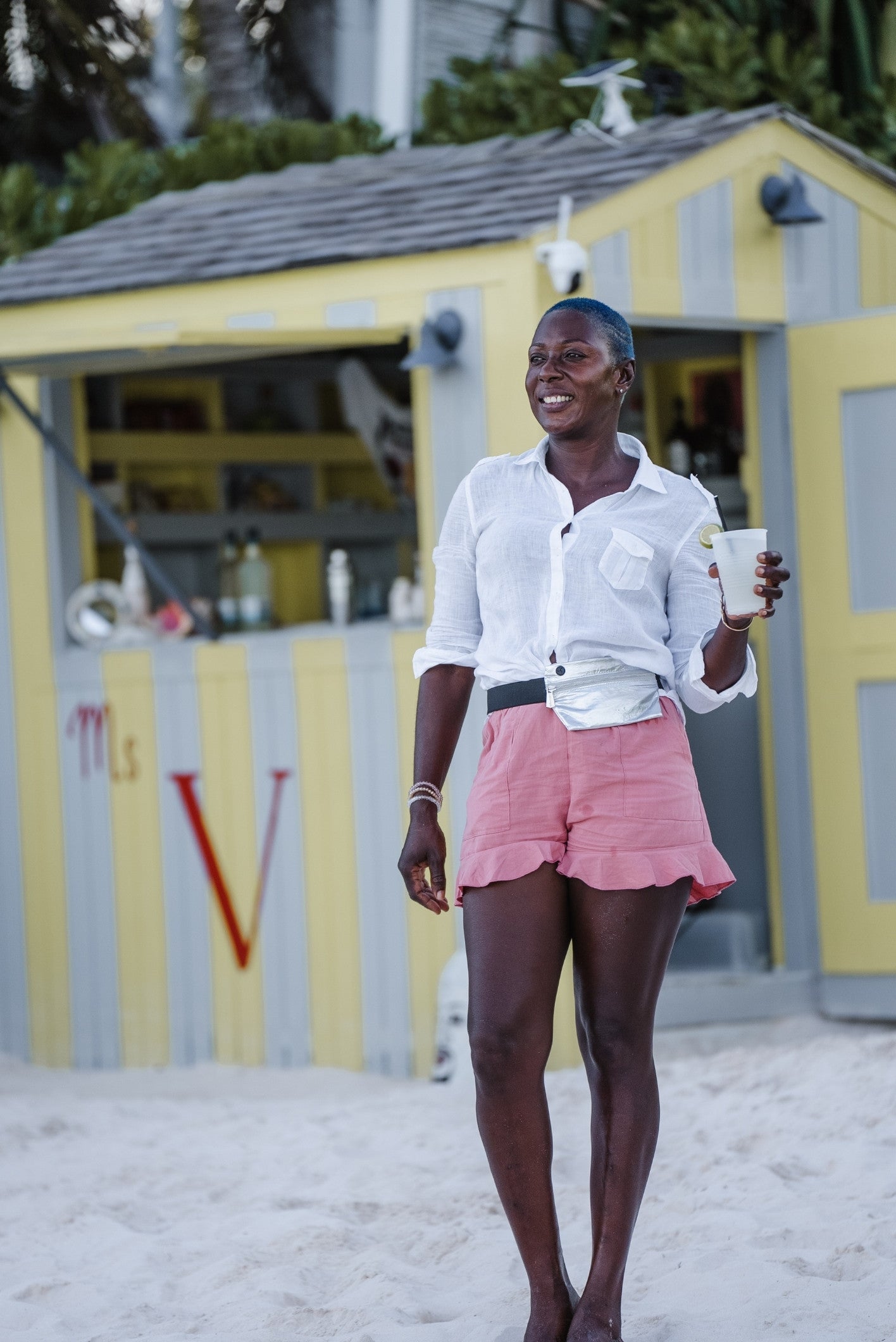 woman on beach wearing silver fanny pack