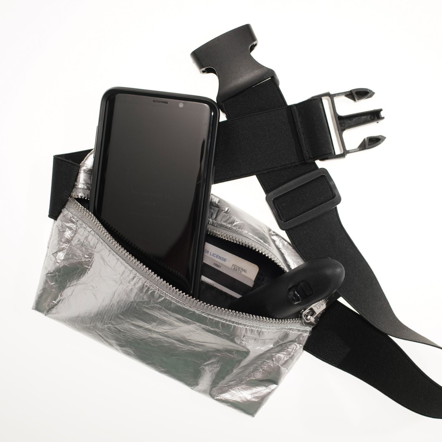 Layflat Fanny Pack Belt Bag in Silver with everyday essentials on white background